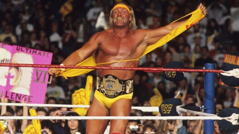 Hulk Hogan stands in the WWE ring, saluting fans during one of his final public appearances, wearing his iconic red and yellow gear.